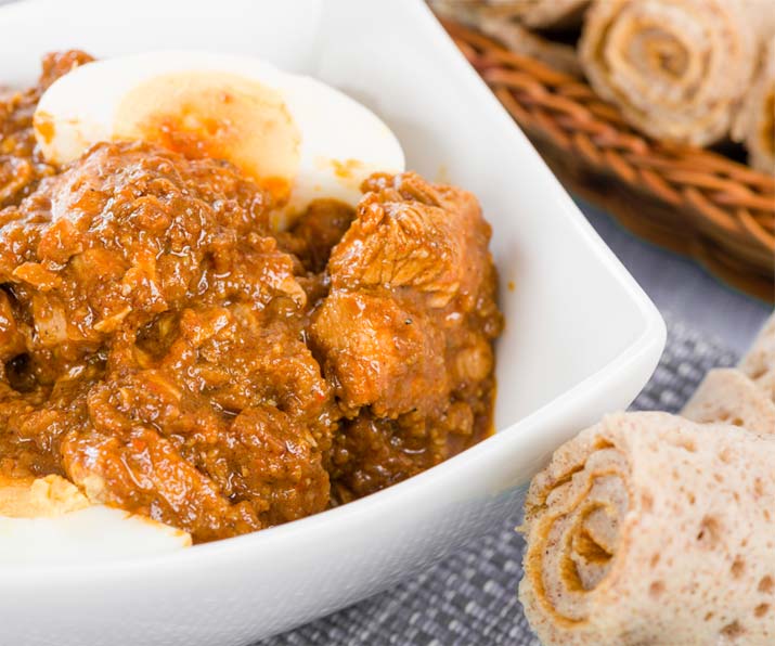 Doro Wot, traditional Ethiopian spicy chicken stew served with injera at Red Sea Restaurant in Oakland Park, Florida