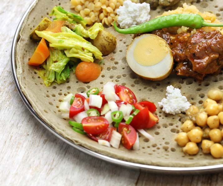 Ethiopian vegetarian combination platter with lentils, greens, cabbage, and injera in Oakland Park, Florida