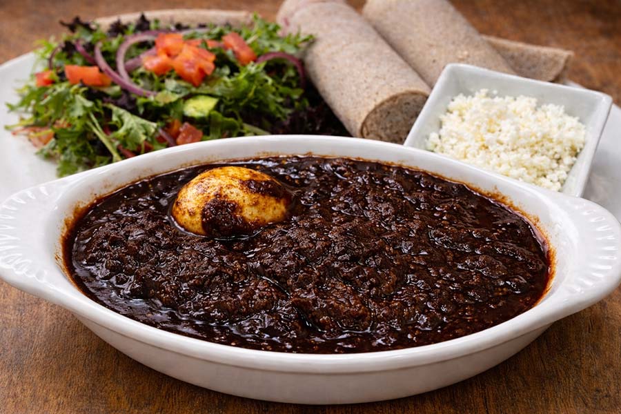 Doro Wot traditional Eritrean and Ethiopian chicken stew with egg served with injera at Red Sea Restaurant in Oakland Park Florida
