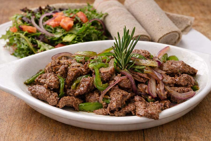 Derek Tibs traditional Eritrean and Ethiopian sautéed beef with onions and peppers served with injera at Red Sea Restaurant in Oakland Park Florida