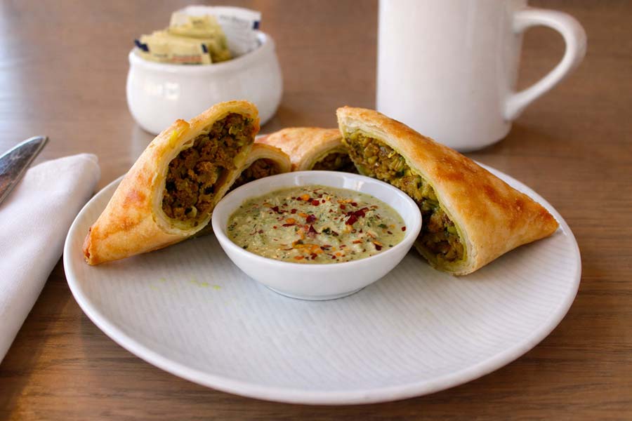 Eritrean and Ethiopian sambusa appetizer with spiced filling served with dipping sauce at Red Sea Restaurant in Oakland Park Florida